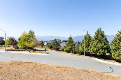 an empty street with a street light and trees at Tranquil 2-Bedroom Basement Suite Relaxing Stay in Chilliwack