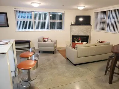 a living room with two couches and a fireplace at Forest Hills in North Vancouver