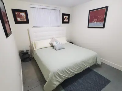 a bedroom with a white bed in a room at Forest Hills in North Vancouver