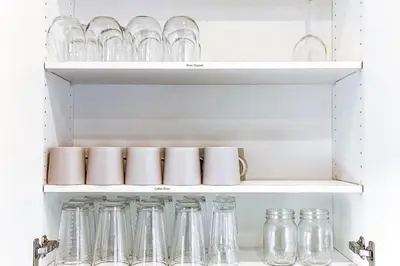 a row of glass jars and bottles on a shelf at 9BDRM Chic Luxury Retreat-Hot Tub-BBQ-Sleeps 23! in Edmonton