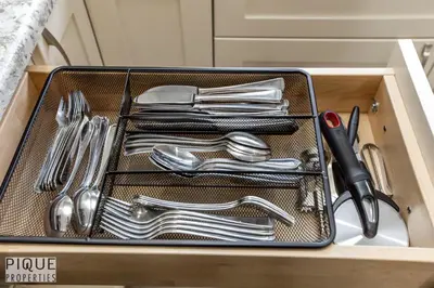 a drawer with silver utensils in a box at Dual-Suite Getaway - Sleeps 12 - Whyte Ave - NFLX in Edmonton