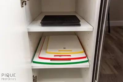 a white shelf with two pizza boxes on it at Dual-Suite Getaway - Sleeps 12 - Whyte Ave - NFLX in Edmonton
