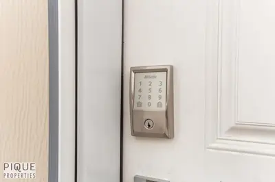 a close up of a door with a remote control at Dual-Suite Getaway - Sleeps 12 - Whyte Ave - NFLX in Edmonton
