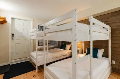a bedroom with two bunk beds in a house at Private Hot Tub | Free Parking | Pool | Sauna in Whistler