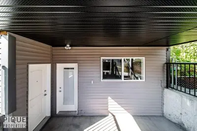 a house with a white door and a porch at Bright Modern Suites-King Beds-NFLX-WiFi-LongStays in Edmonton