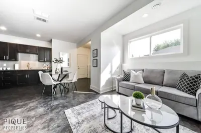 a living room with a couch and a table at Bright Modern Suites-King Beds-NFLX-WiFi-LongStays in Edmonton