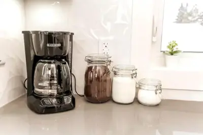 a blender and two jars of milk on a counter at 5BDRM Chic Modern Home-Hot Tub-King Bed-AC-Garage in Edmonton