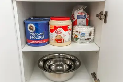 a pantry with a shelf with food and a bowl at 5BDRM Chic Modern Home-Hot Tub-King Bed-AC-Garage in Edmonton