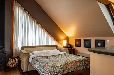 a bedroom with a bed and a large window at Timberloft by Revelstoke Vacations in Revelstoke