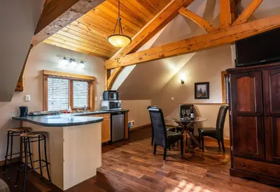 a kitchen with a bar and a dining room at Timberloft by Revelstoke Vacations in Revelstoke