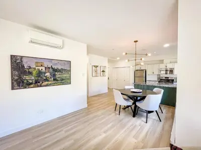 a kitchen and dining room with a table and chairs at Lakeview Retreat in West Kelowna in West Kelowna