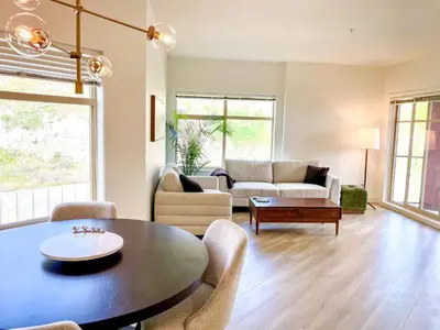 a living room with a table and a couch at Lakeview Retreat in West Kelowna in West Kelowna