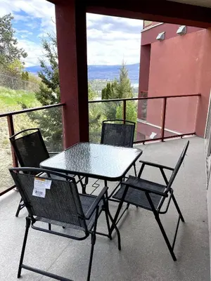 a table and chairs on a balcony with a view at Lakeview Retreat in West Kelowna in West Kelowna