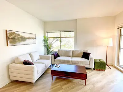a living room with two couches and a coffee table at Lakeview Retreat in West Kelowna in West Kelowna