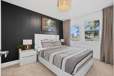 a bedroom with a bed and a black wall at *One of a Kind* | Hot Tub| Air Hockey| Pool and… in Calgary