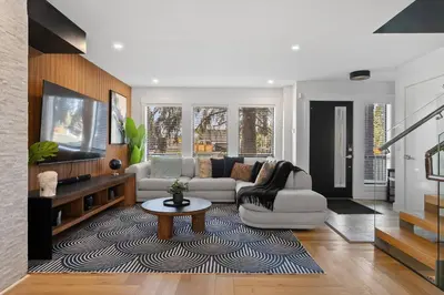 a living room with a couch and a table at *One of a Kind* | Hot Tub| Air Hockey| Pool and… in Calgary