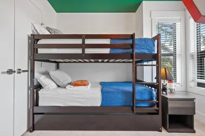 a bedroom with two bunk beds in a room at *Spectacular* Sauna |Rocket-ship|Game-Room|Hammock in Calgary