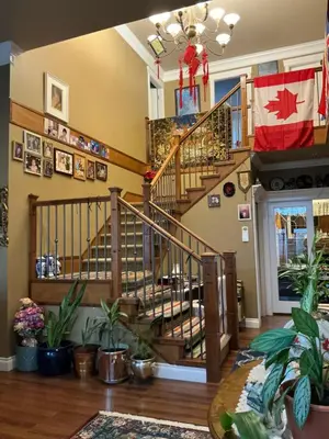 a staircase in a living room with plants at Barry and Elaine in Abbotsford