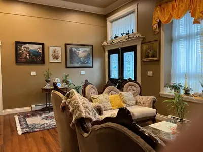 a living room with a couch and some windows at Barry and Elaine in Abbotsford