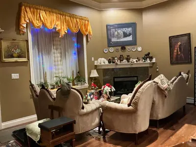 a living room with three chairs and a fireplace at Barry and Elaine in Abbotsford