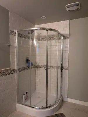 a shower with a glass enclosure in a bathroom at 2-Room Suite in South Edmonton in Edmonton