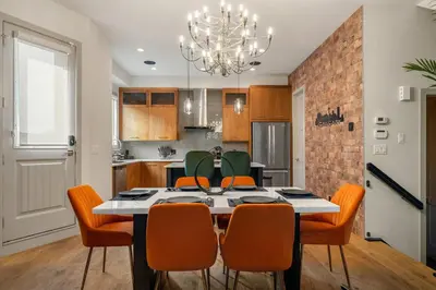 a kitchen and dining room with a table and chairs at *Incredible Location* |Two King Beds| Free Parking in Calgary