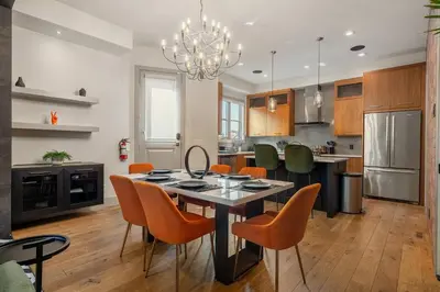 a kitchen and dining room with a table and chairs at *Incredible Location* |Two King Beds| Free Parking in Calgary