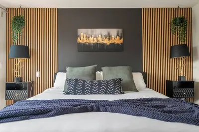 a bedroom with a large bed and two lamps at *Incredible Location* |Two King Beds| Free Parking in Calgary