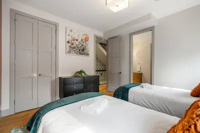a bedroom with two beds and a closet at *Incredible Location* |Two King Beds| Free Parking in Calgary