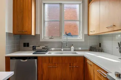 a kitchen with a sink and a window at *Incredible Location* |Two King Beds| Free Parking in Calgary