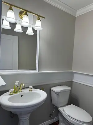 a bathroom with a sink and a toilet and a mirror at Charming 4-Bedroom Home in Bella Coola in Hagensborg