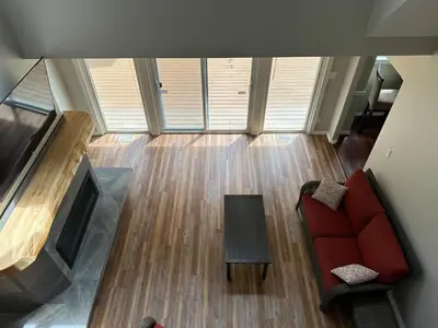 a living room with a red couch and a table at Charming 4-Bedroom Home in Bella Coola in Hagensborg