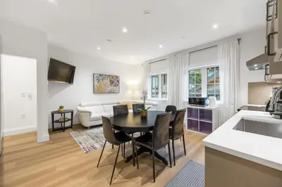 a kitchen and living room with a table and chairs at Brand-New Luxury Dunbar 4BR Home - Near UBC - Sleep 10 - Ideal for Family in Vancouver
