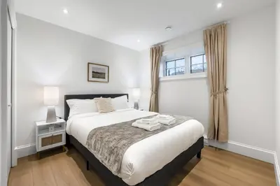 a bedroom with a bed and a window at Brand-New Luxury Dunbar 4BR Home - Near UBC - Sleep 10 - Ideal for Family in Vancouver