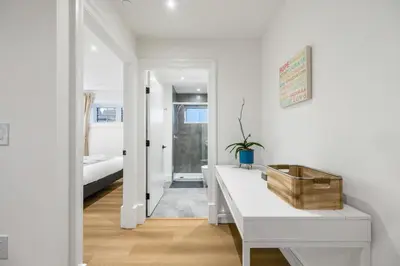 a white room with a white desk and a bedroom at Brand-New Luxury Dunbar 4BR Home - Near UBC - Sleep 10 - Ideal for Family in Vancouver