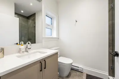 a bathroom with a sink and a toilet at Brand-New Luxury Dunbar 4BR Home - Near UBC - Sleep 10 - Ideal for Family in Vancouver