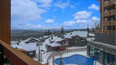 a view from a balcony of a resort in the snow at Stonegate Resort Unit C403 in Big White