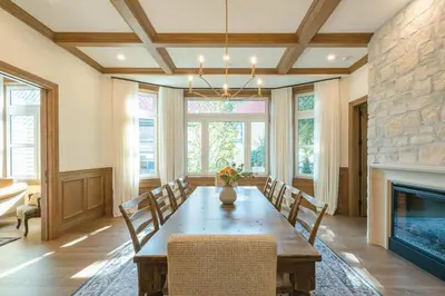 a dining room with a table and a fireplace at Samson House in Revelstoke