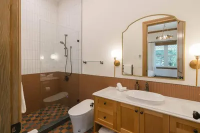 a bathroom with a sink and a toilet and a mirror at Samson House in Revelstoke