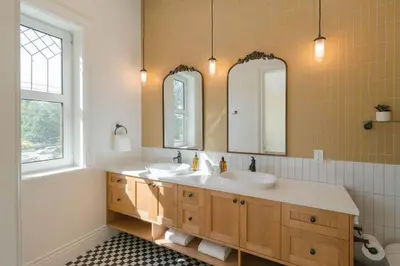 a bathroom with two sinks and two mirrors at Samson House in Revelstoke