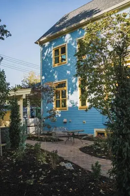 a blue house with a picnic table in front of it at Samson House in Revelstoke