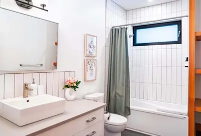 a white bathroom with a sink and a toilet at Cartier Chalet in Revelstoke
