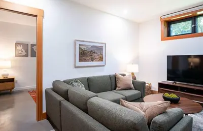 a living room with a couch and a flat screen tv at Cartier Chalet in Revelstoke