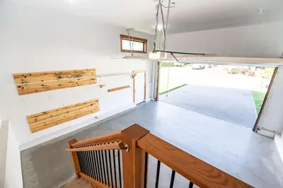 a room with a wooden staircase and a window at Cartier Chalet in Revelstoke