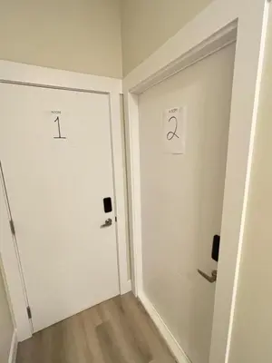 a hallway with a white door with numbers on it at Prince George Cozy Suite in Prince George