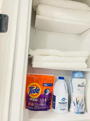 a refrigerator with towels and a box and milk at Ivey Homes in Edmonton