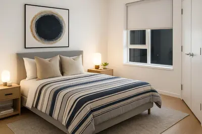 a bedroom with a bed and two lamps and a window at Urban Two-Bedroom Apartment with Prime Downtown Location in Vancouver