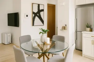 a dining room with a glass table and chairs at Urban Two-Bedroom Apartment with Prime Downtown Location in Vancouver