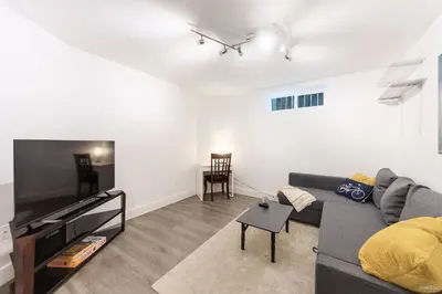 a living room with a couch and a flat screen tv at Lynn Valley 2BR Suite By Grouse Mtn & Lynn Canyon in North Vancouver