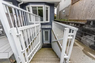 a stairway leading up to a house with white railings at Lynn Valley 2BR Suite By Grouse Mtn & Lynn Canyon in North Vancouver
